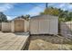 Backyard with large patio featuring landscaping and storage sheds at 641 Hartley Ave, Deltona, FL 32725