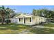 Newly built yellow house with covered porch and side yard at 642 Bellevue Ave, Daytona Beach, FL 32114