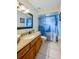 Bathroom with vanity, granite countertop, and a shower with blue patterned curtain at 709 Lone Oak Dr, Port Orange, FL 32127