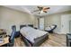 A bright bedroom with a ceiling fan, plank floors, and a comfortable bed at 709 Lone Oak Dr, Port Orange, FL 32127