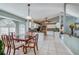 Bright dining room features a wooden table set, white tile floors, and white kitchen cabinets at 709 Lone Oak Dr, Port Orange, FL 32127