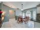 Dining area with elegant wood table set, bright bay window, and granite countertops at 709 Lone Oak Dr, Port Orange, FL 32127