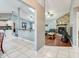 Open-concept living space with tile floors, a brick fireplace, and a view of the kitchen and adjoining rooms at 709 Lone Oak Dr, Port Orange, FL 32127