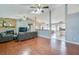 Open-concept living room features hardwood floors, a brick fireplace, and plenty of natural light at 709 Lone Oak Dr, Port Orange, FL 32127