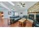Cozy living room featuring hardwood floors, a brick fireplace, comfortable seating, and French doors to an enclosed room at 709 Lone Oak Dr, Port Orange, FL 32127