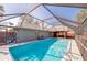 Screened-in pool area featuring a clear blue pool, lounge chairs, and outdoor living space at 709 Lone Oak Dr, Port Orange, FL 32127
