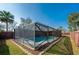 Screened-in pool and patio surrounded by well-maintained landscaping and a privacy fence at 709 Lone Oak Dr, Port Orange, FL 32127