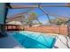 Beautiful screened-in pool area with a clear blue pool, outdoor living space, and lush backyard at 709 Lone Oak Dr, Port Orange, FL 32127