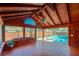 Spacious sunroom featuring a tongue-and-groove ceiling, tile floor, large windows, and views of the screened-in pool at 709 Lone Oak Dr, Port Orange, FL 32127