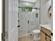 Modern bathroom with a walk-in shower, marble tile and floating vanity at 731 E Cox St, Deland, FL 32724