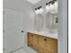 Double vanity bathroom with hexagon tile flooring and arched mirrors at 731 E Cox St, Deland, FL 32724