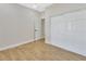 Bedroom with wood-look floors, white closet doors and an additional door at 731 E Cox St, Deland, FL 32724