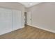 Bedroom with wood-look floors and white closet doors at 731 E Cox St, Deland, FL 32724