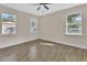 Bright bedroom featuring two windows and wood-look tile flooring at 731 E Cox St, Deland, FL 32724