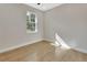 Well-lit bedroom featuring wood-look floors and a window at 731 E Cox St, Deland, FL 32724