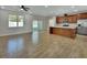 Open kitchen with island, stainless steel appliances, and wood cabinets at 731 E Cox St, Deland, FL 32724