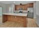 Modern kitchen with stainless steel appliances and wood cabinets at 731 E Cox St, Deland, FL 32724