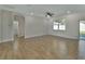 Open living room with wood-look floors and access to a bathroom at 731 E Cox St, Deland, FL 32724