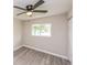 Bright bedroom with ceiling fan and wood-look floors at 916 Tracy St, Daytona Beach, FL 32117