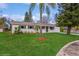 Newly renovated single-story home with a landscaped lawn and driveway at 916 Tracy St, Daytona Beach, FL 32117