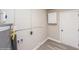 Convenient laundry room with storage cabinet and vinyl flooring at 916 Tracy St, Daytona Beach, FL 32117