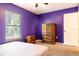 Purple bedroom with double bed, wood dresser and window at 101 Los Arbor Dr, Deland, FL 32724