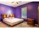 Purple bedroom with double bed and wood furniture at 101 Los Arbor Dr, Deland, FL 32724
