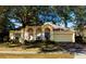 House exterior featuring stone accents and a two-car garage at 101 Los Arbor Dr, Deland, FL 32724