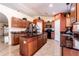 Kitchen showcasing granite countertops, a center island, and modern appliances at 101 Los Arbor Dr, Deland, FL 32724
