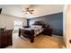 Spacious main bedroom with a dark-wood bed frame and a blue accent wall at 101 Los Arbor Dr, Deland, FL 32724