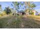 Landscaped backyard with grassy area and mature trees at 1137 Avery Meadows Way, Deland, FL 32724