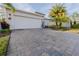 Home with paver driveway, landscaping and two-car garage at 1137 Avery Meadows Way, Deland, FL 32724