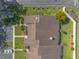 Top-down aerial view of townhome rooftops and well-manicured lawns with flowerbeds at 1260 Charter Oaks Cir, Daytona Beach, FL 32117
