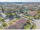 Community aerial showing townhomes, pool, and parking areas amid lush trees at 1260 Charter Oaks Cir, Daytona Beach, FL 32117