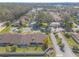 Overhead view of townhomes, pool, and parking, surrounded by mature landscaping at 1260 Charter Oaks Cir, Daytona Beach, FL 32117