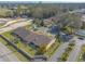 Drone shot showcases townhome complex, mature trees, parking, and community sign at 1260 Charter Oaks Cir, Daytona Beach, FL 32117
