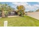 Landscaped backyard with grassy area and privacy wall at 1260 Charter Oaks Cir, Daytona Beach, FL 32117