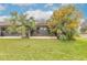 Private backyard with grassy lawn and tropical plants at 1260 Charter Oaks Cir, Daytona Beach, FL 32117