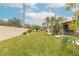 Grass lawn, privacy wall, and tropical landscaping at 1260 Charter Oaks Cir, Daytona Beach, FL 32117