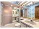 Bathroom with shower/tub combo, vanity, and patterned wallpaper at 1260 Charter Oaks Cir, Daytona Beach, FL 32117