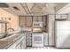 Galley style kitchen with white appliances and ample cabinet space at 1260 Charter Oaks Cir, Daytona Beach, FL 32117
