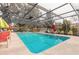Community pool with covered patio and lounge chairs at 1260 Charter Oaks Cir, Daytona Beach, FL 32117