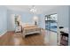 Bright bedroom with light wood floors and sliding glass doors at 129 Oyster Catcher Ct, Daytona Beach, FL 32119