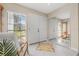 Bright foyer with tiled floor, mirrored wall, and view to backyard at 129 Oyster Catcher Ct, Daytona Beach, FL 32119