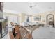 Open living room with vaulted ceiling, white sectional sofa and fireplace at 129 Oyster Catcher Ct, Daytona Beach, FL 32119
