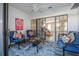 Bright sunroom with blue seating and view of the backyard at 129 Oyster Catcher Ct, Daytona Beach, FL 32119