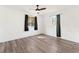 Bedroom with wood-look floors, ceiling fan, and window at 1331 Granada Ave, Daytona Beach, FL 32117