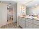 Double vanity bathroom with granite countertop and access to toilet at 1420 N Atlantic Ave # 1102, Daytona Beach, FL 32118