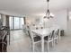 Dining room with white table, gray chairs, and a chandelier at 1420 N Atlantic Ave # 1102, Daytona Beach, FL 32118