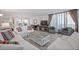 Bright living room with comfy sofas, a large TV, and a coffee table at 1420 N Atlantic Ave # 1102, Daytona Beach, FL 32118